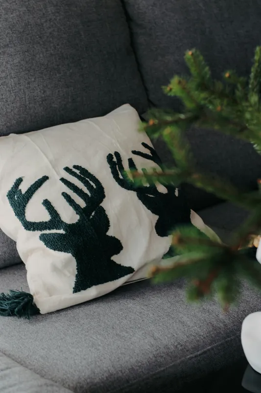 Chenille reindeer embroidery on a decorative cushion